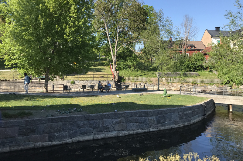 Gröna ön i Norrtälje med parkbänkar för avkoppling.